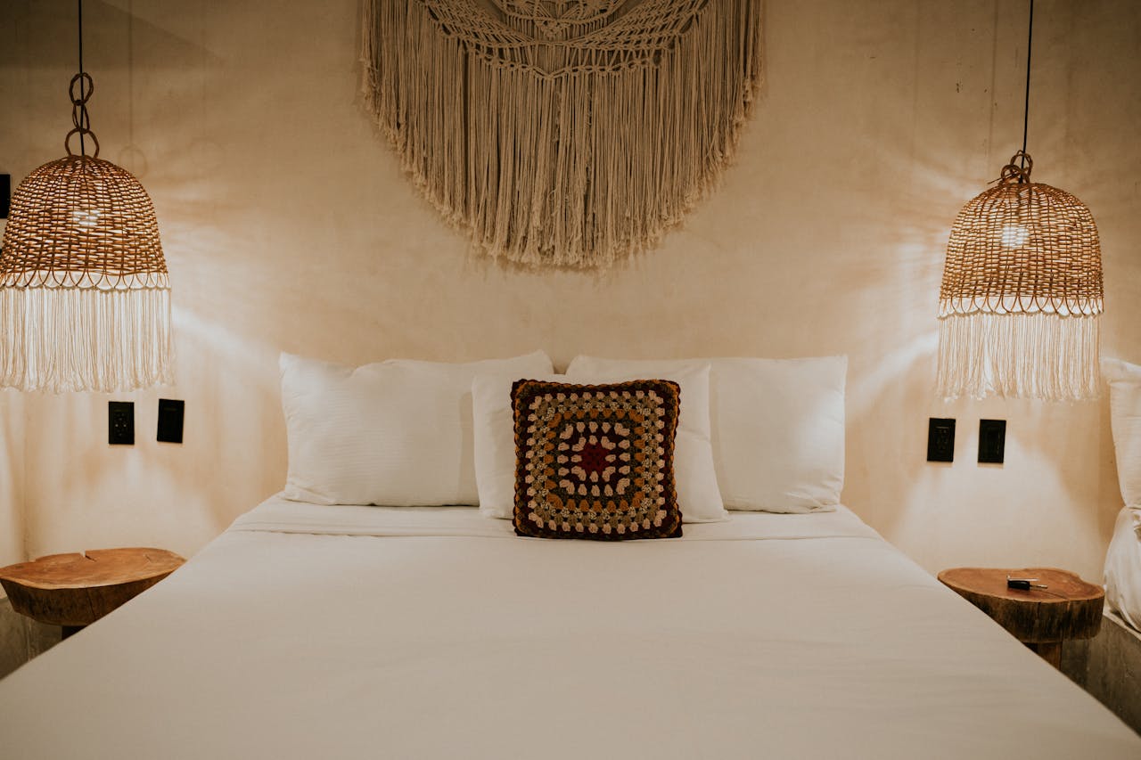Warm bohemian bedroom with macrame decor and wicker lampshades for a cozy ambiance.